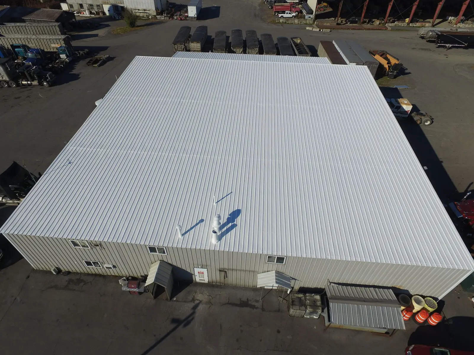 Aerial view of a commercial building with a metal roof