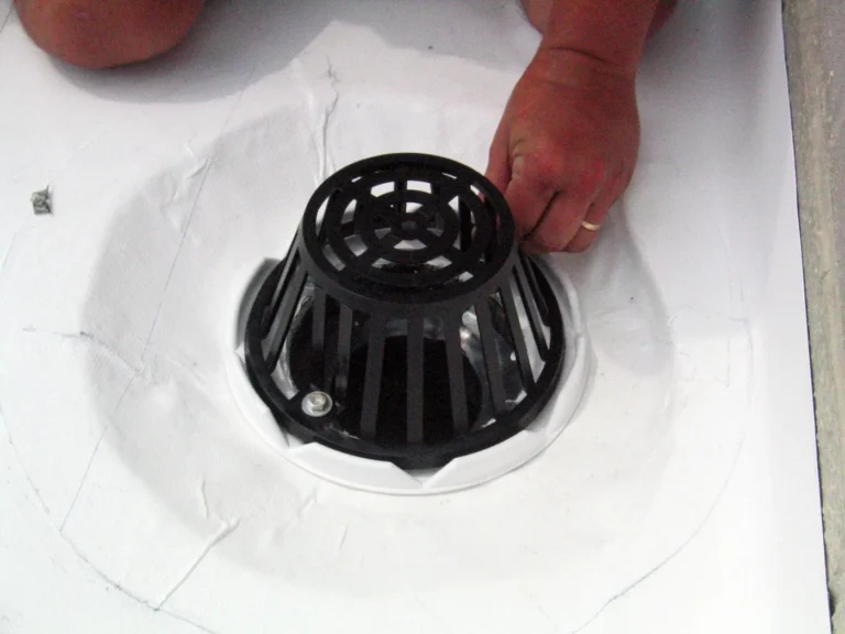 Roof drain sealed and detailed in a white coating system