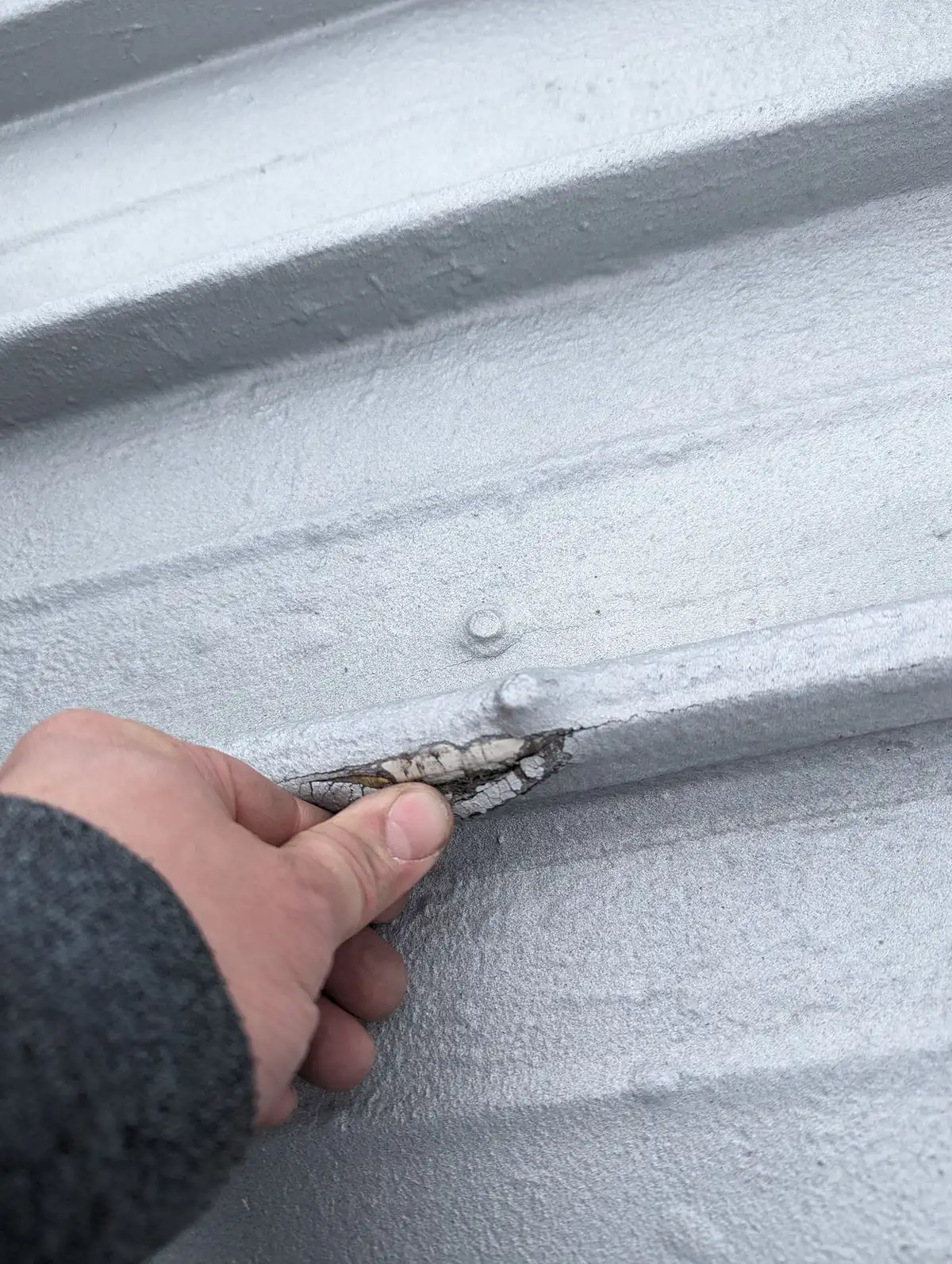 Sealing exposed fasteners along a metal roof seam